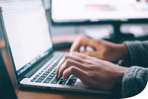 person typing on a laptop